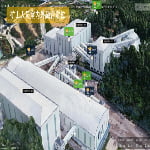 Aerial view of an industrial mining facility with several large white buildings and connected conveyor belts, featuring labeled points in Chinese for personnel location tracking.