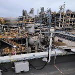 TXWG communication gateway installed in chemical plant environment with industrial pipelines and multi-antenna setup.