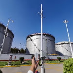 Demonstration of TXWG communication gateway deployment showing handheld terminal and long-range antennas.