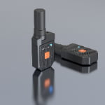 Two black handheld communication devices with visible SOS buttons and indicator lights are placed on a reflective gray surface.