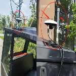 Side-by-side images showing antennas mounted on a vehicle roof; the left image highlights a GNSS antenna, and the right image labels both GNSS and UWB antennas with red arrows and text.
